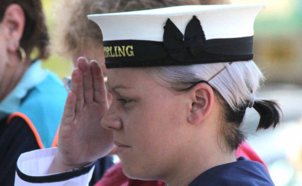 Able Seaman Crystal Schulz pays tribute to the fallen. Able Seaman Crystal Schulz pays tribute to the fallen.
